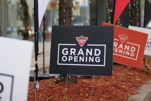 Outdoor signage promoting Canadian Tire grand opening event.