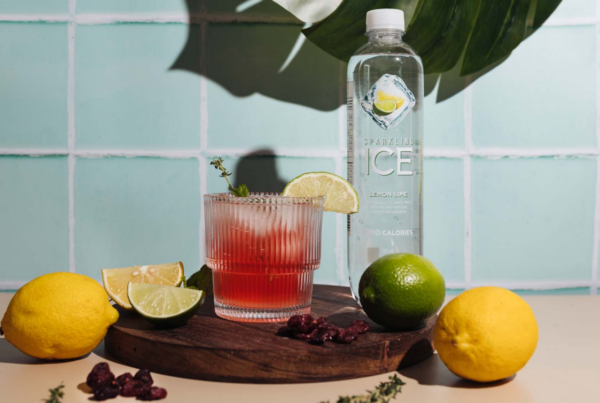 Sparkling Ice Lemon Lime drink with garnished glass and fruits.