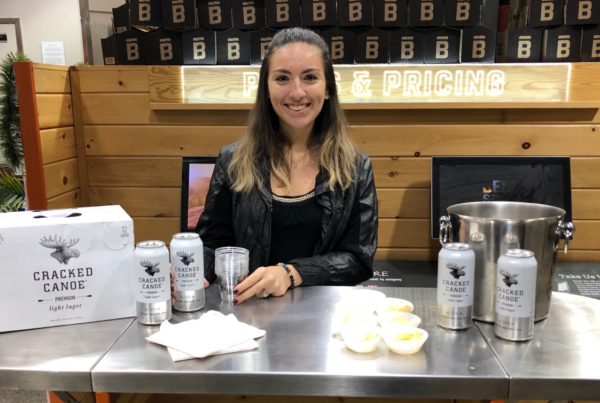 Cracked Canoe light lager sampling setup with smiling host.