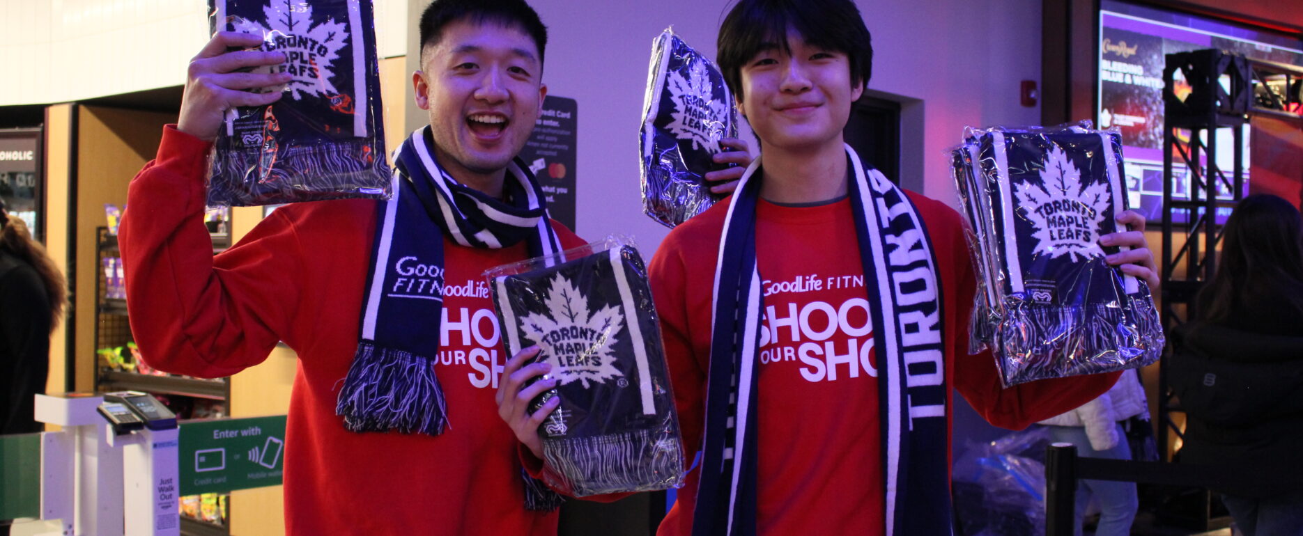 GoodLife Fitness brand ambassadors holding Toronto Maple Leafs merchandise.