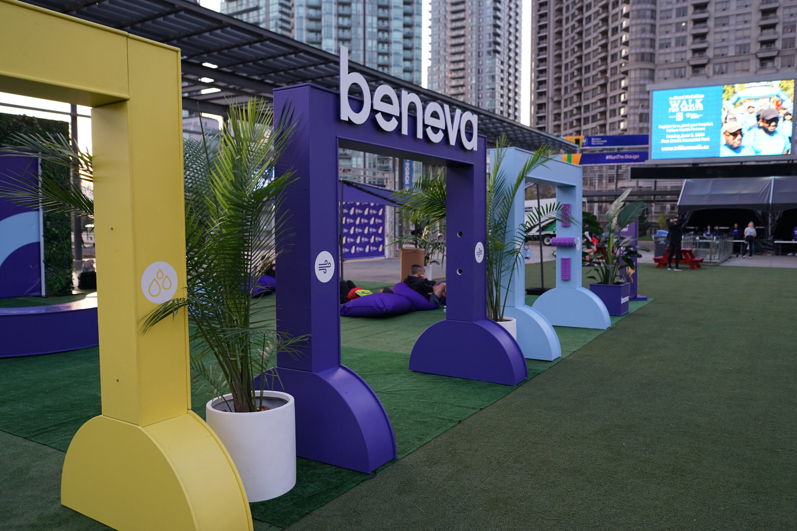Beneva sponsorship activation display with branded archways and greenery